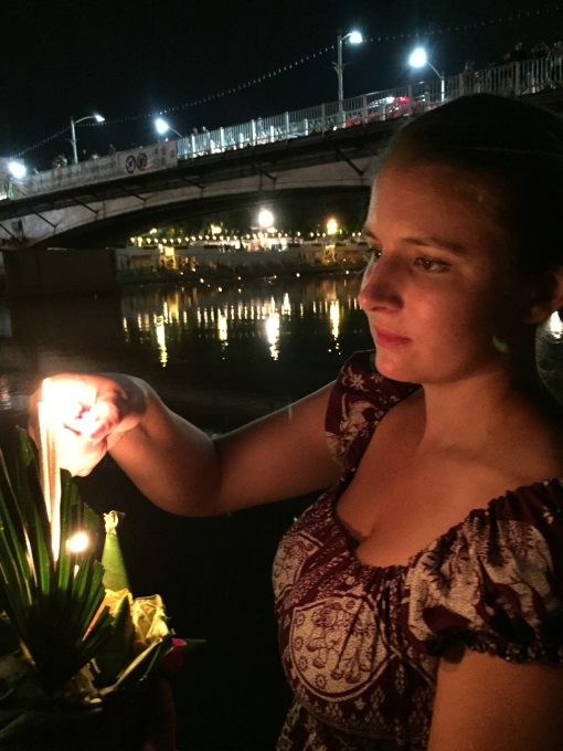 Light a floating Krathong for the Buddhist celebration of Loy Krathon in Chiang Mai, Thailand